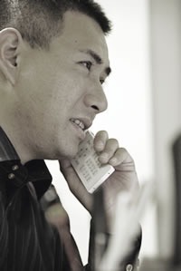 電話で打ち合わせをする代表